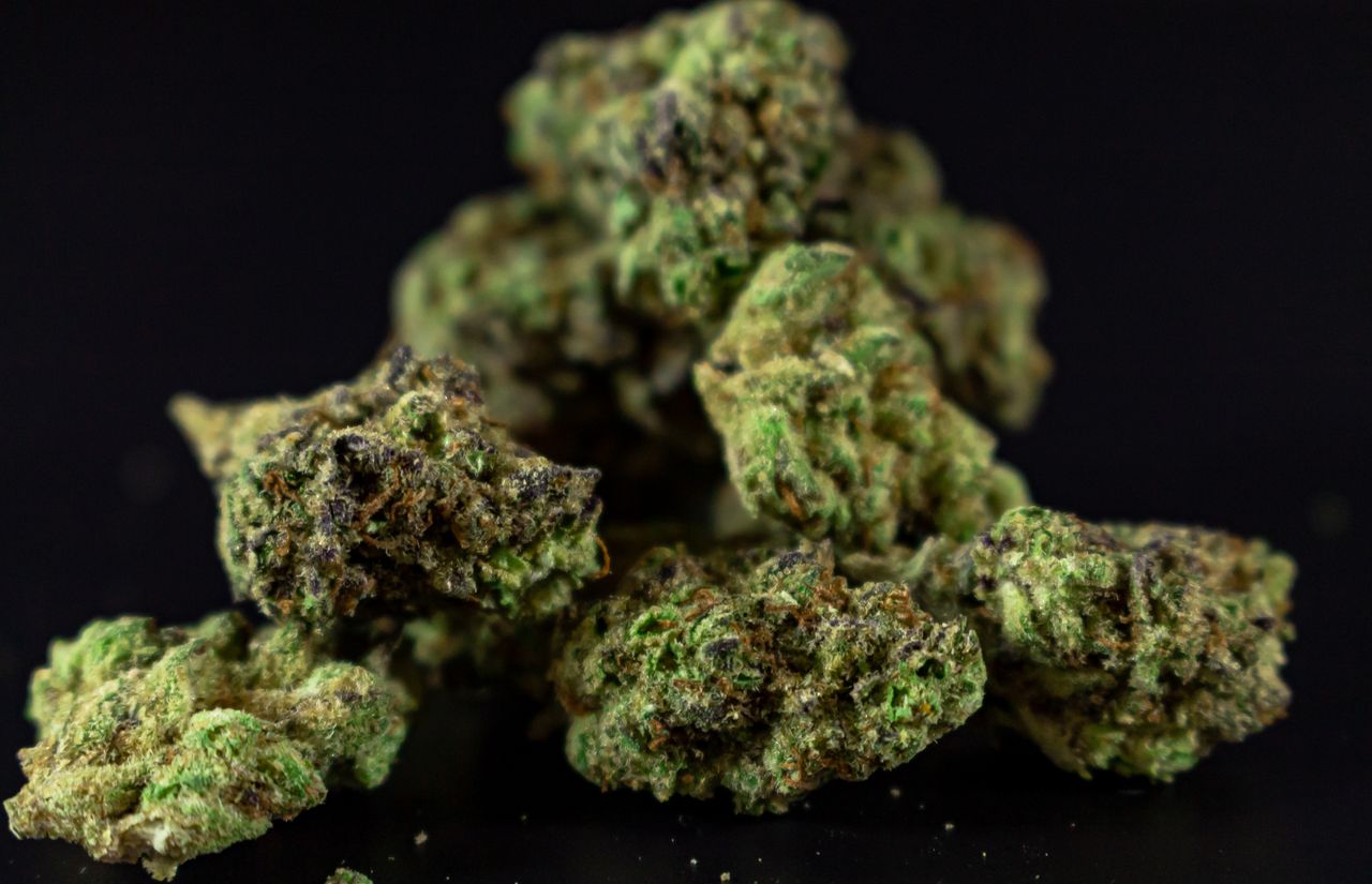 Mastering the First Impression: Your intriguing post title goes here Macro shot of dried cannabis buds showcasing texture and detail on black backdrop.